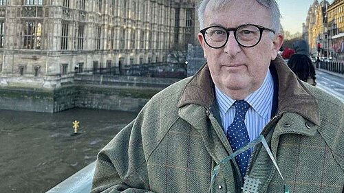 Jamie Stone MP stood on Westminster Bridge